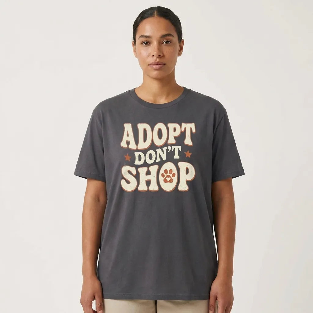 Person wearing a gray t-shirt with 'ADOPT DON'T SHOP' text and paw print design on a white background