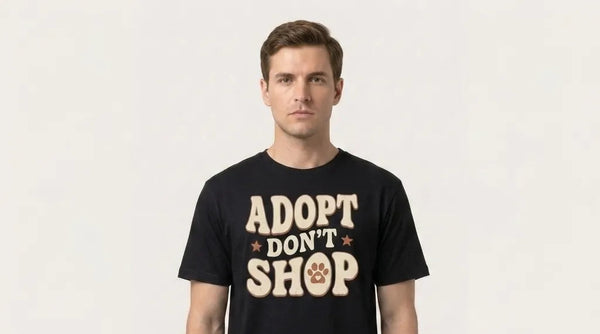 Man wearing a black t-shirt with 'Adopt Don't Shop' text on a plain background
